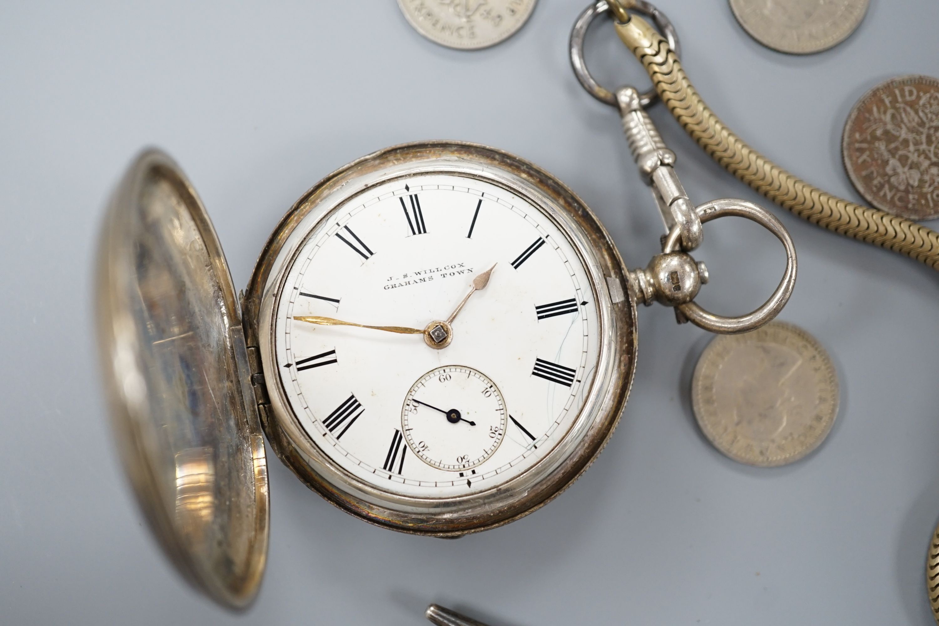 A late Victorian silver hunter keywind pocket watch, by Willcox of Grahams Town, one other white metal pocket watch, assorted minor coins and a sterling pen.